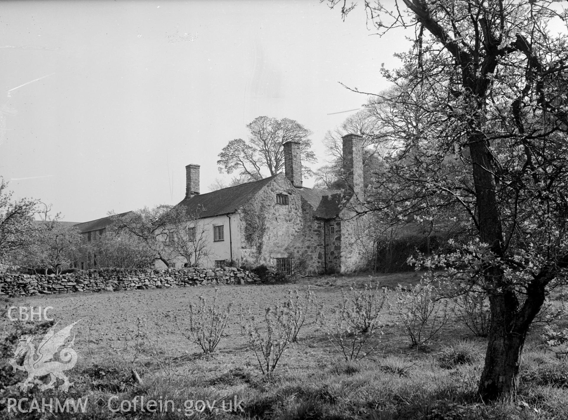 A photograph of a 17th century two storey stone manor house, with pitched roofing.