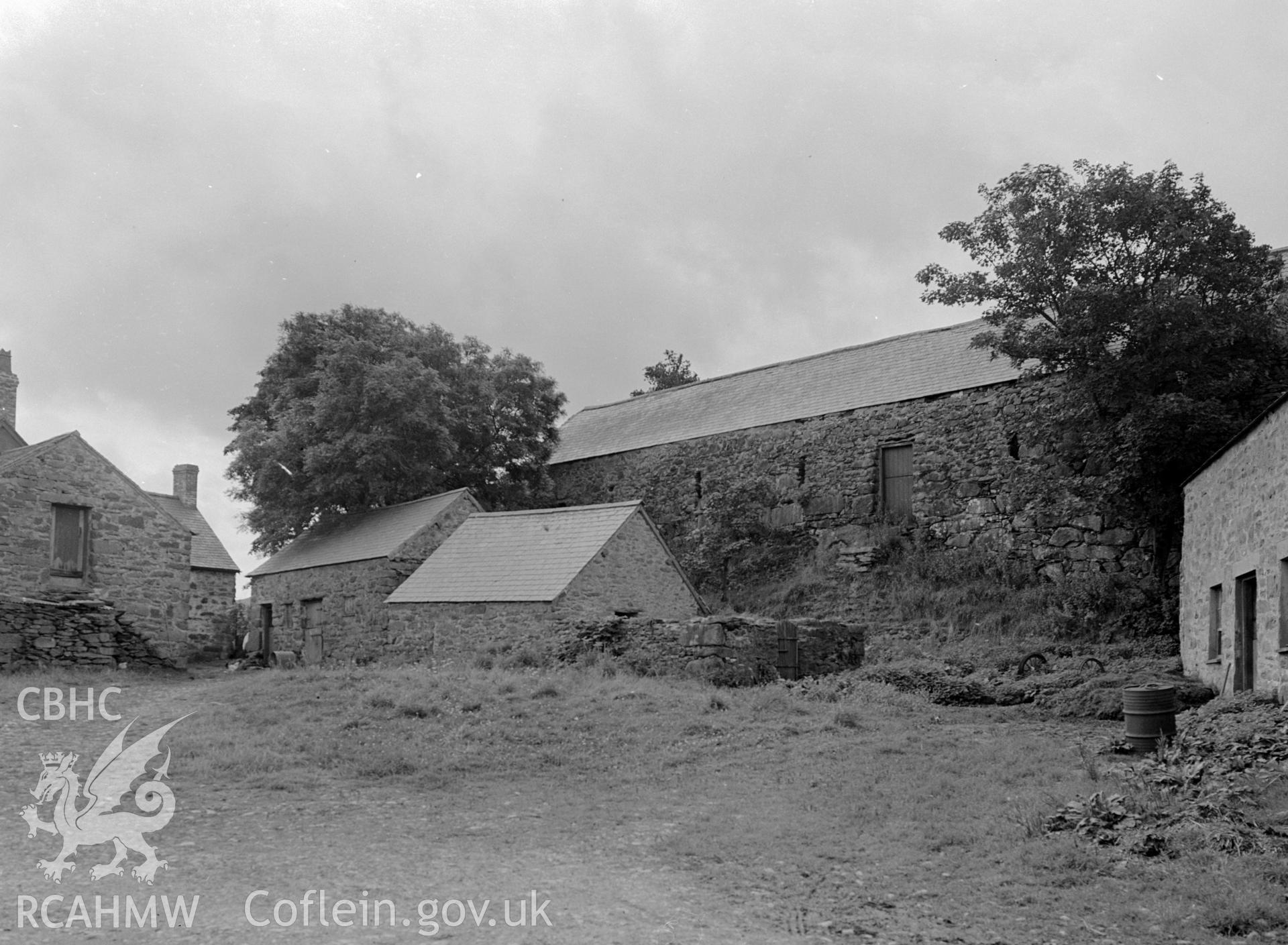 A photograph of stone outbuildings of various sizes and shapes.