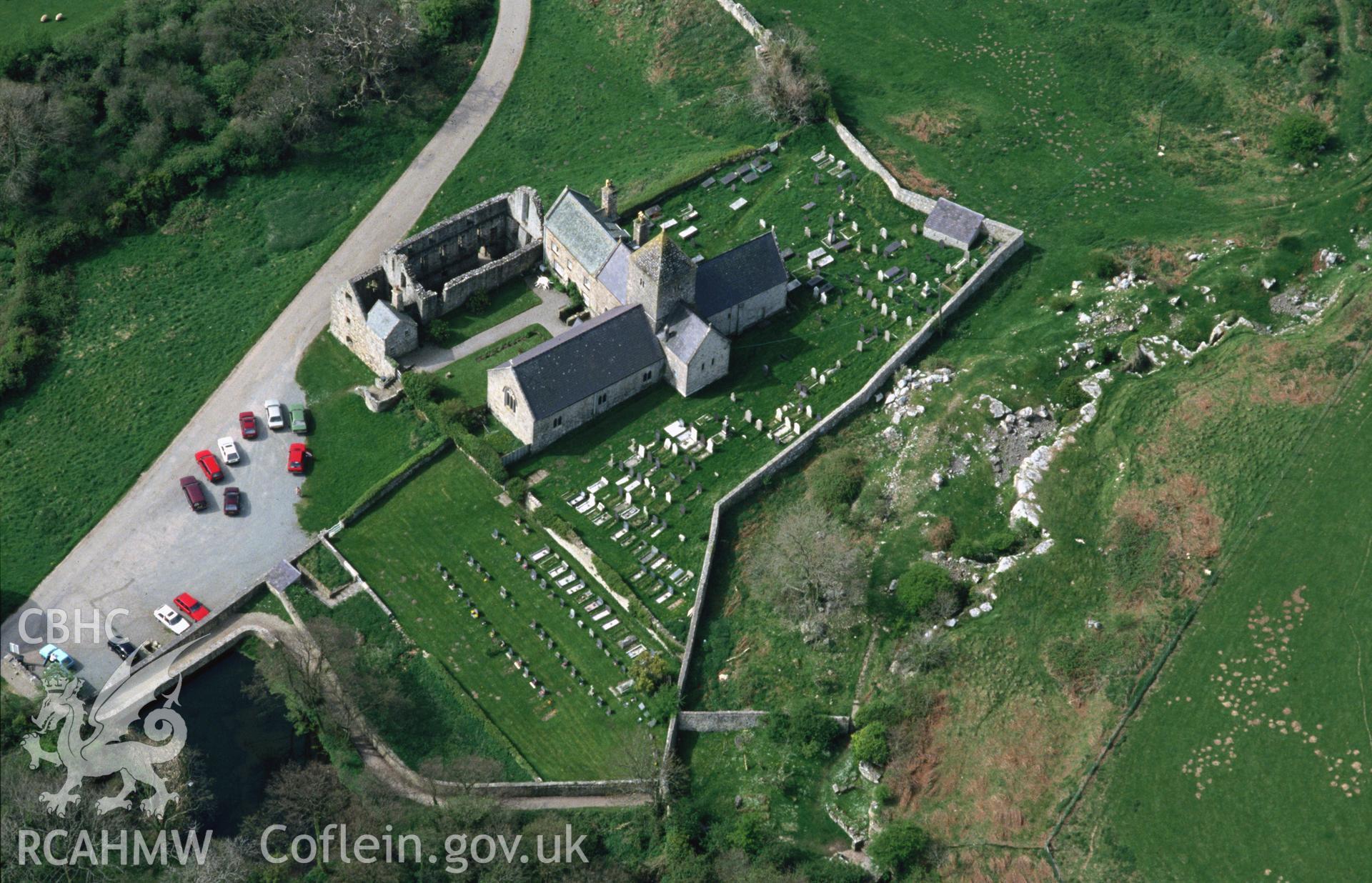 RCAHMW colour slide oblique aerial photograph of Penmon Priory, Penmon, taken by C.R. Musson, 01/05/94