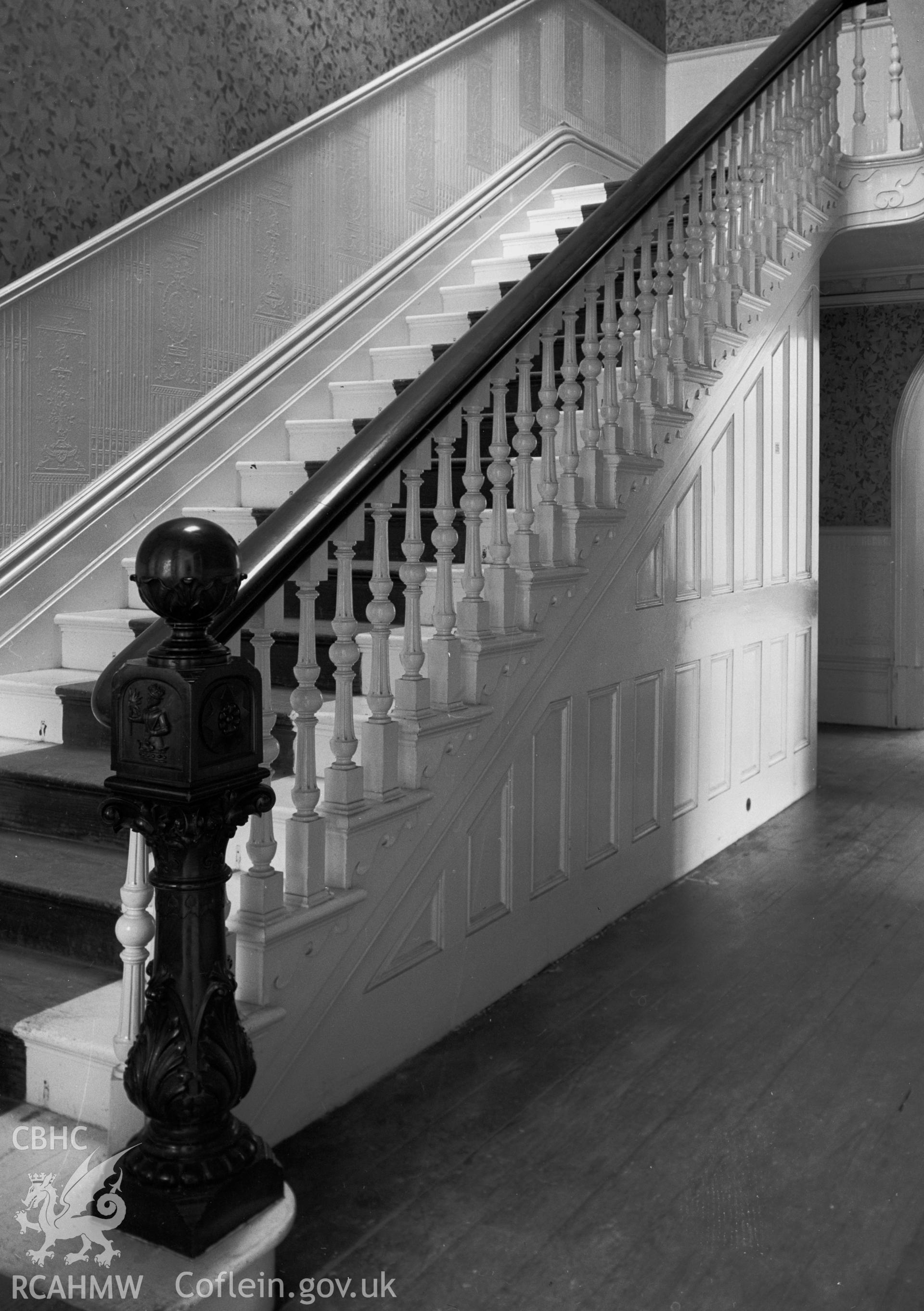 A view of a large staircase with wooden banister.