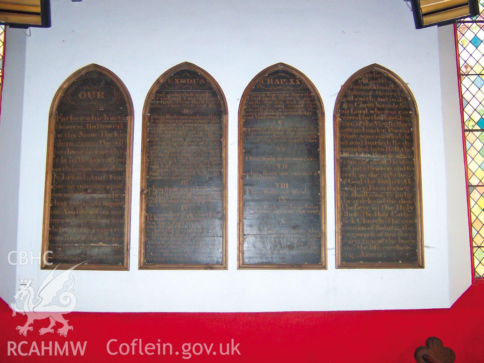 Colour digital photograph of plaques on an interior church wall, displaying the ten commandments.