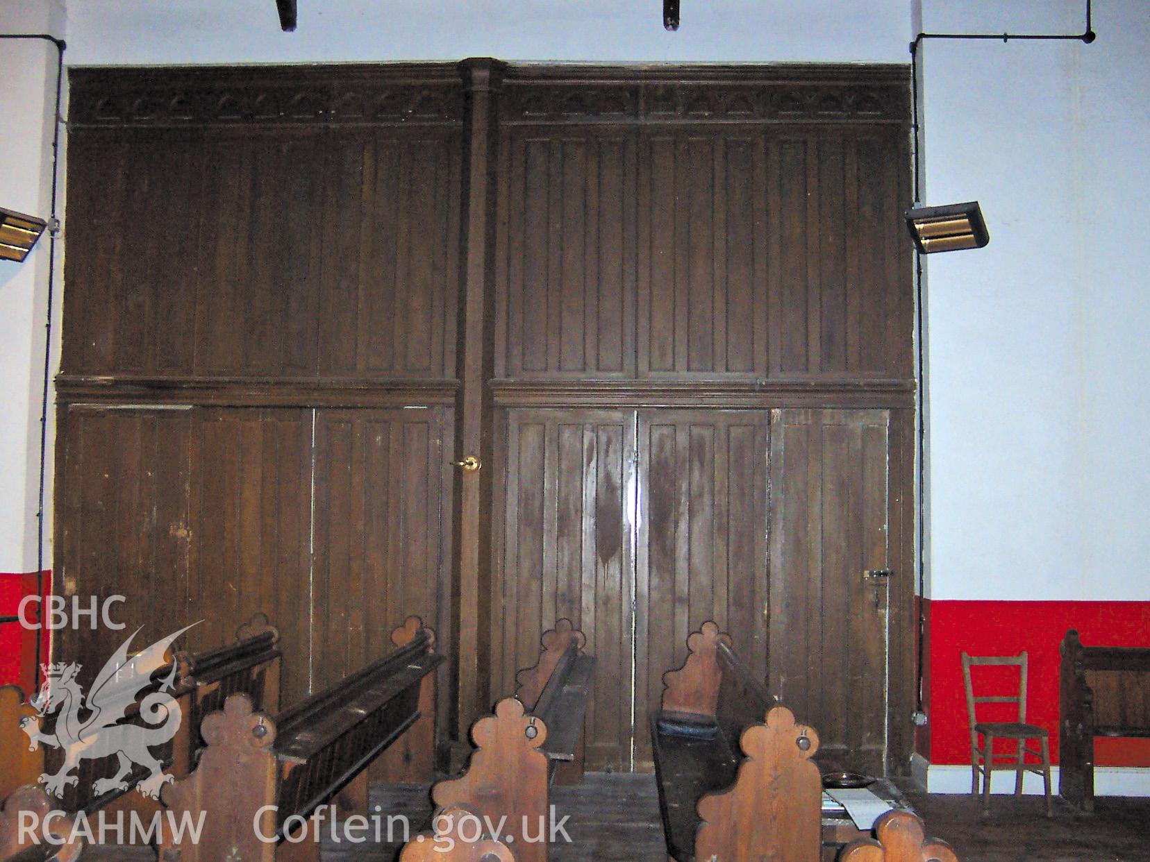 Colour digital photograph of the wooden panelling between the church and the school room.