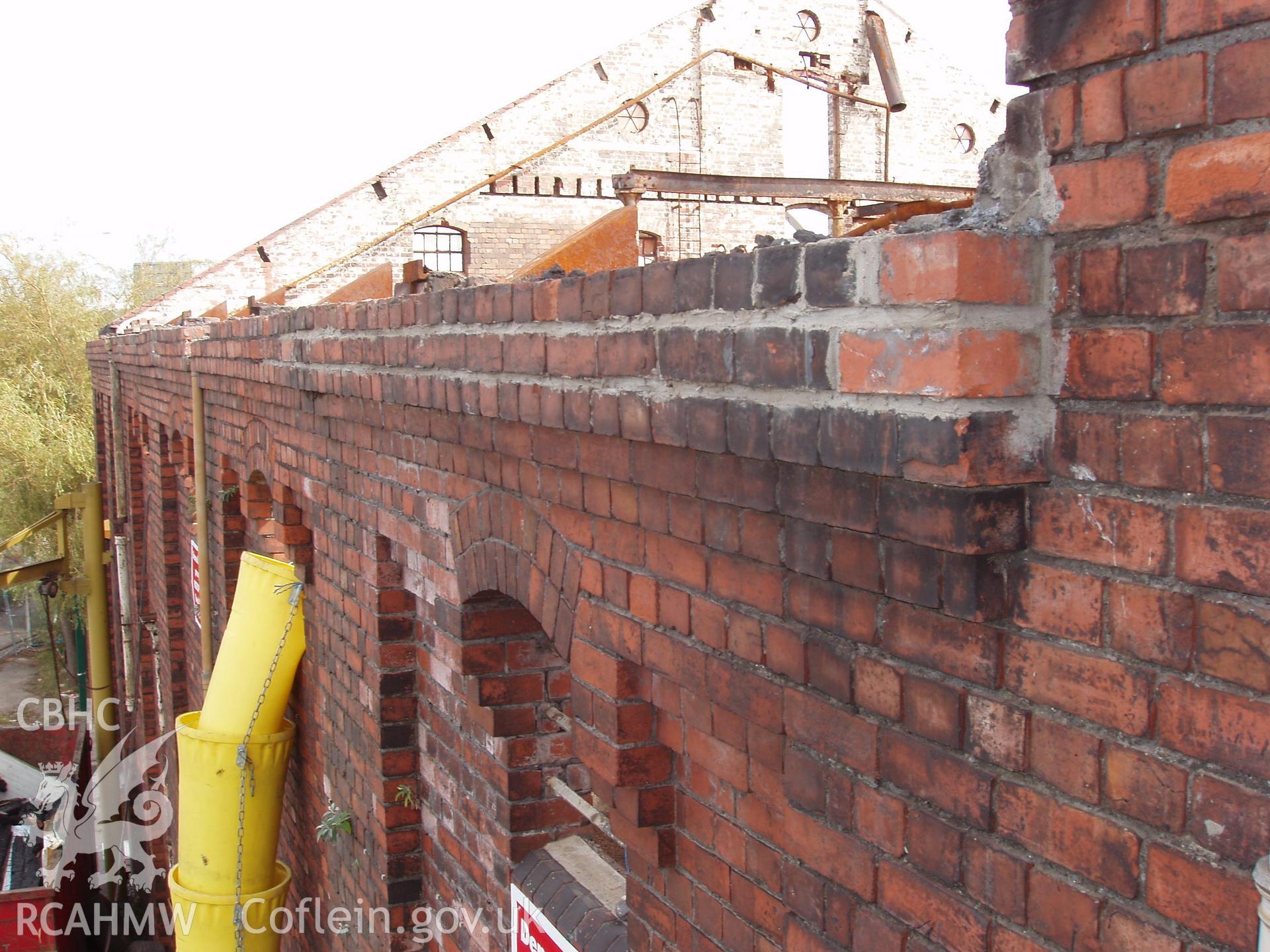 Colour digital photograph showing part of an exterior wall and the remains of the Malt House roof, East Dock Road, Newport.  The photograph was taken after the Malt House was severely damaged by fire.