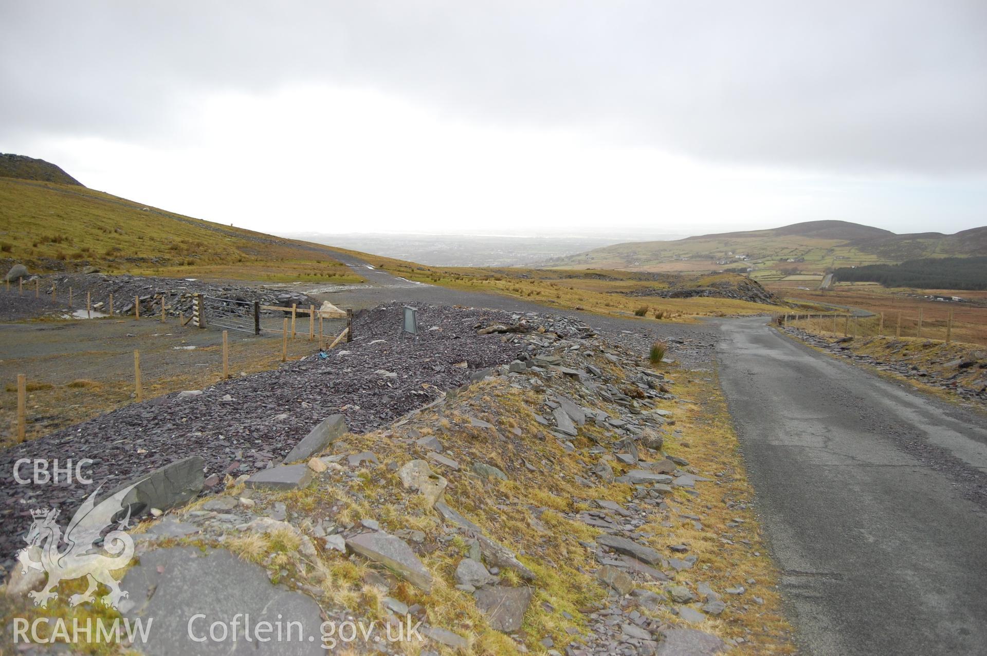 Colour digital image of Mynydd Llandegai showing the road passing the edge of Marchlyn Quarry.
