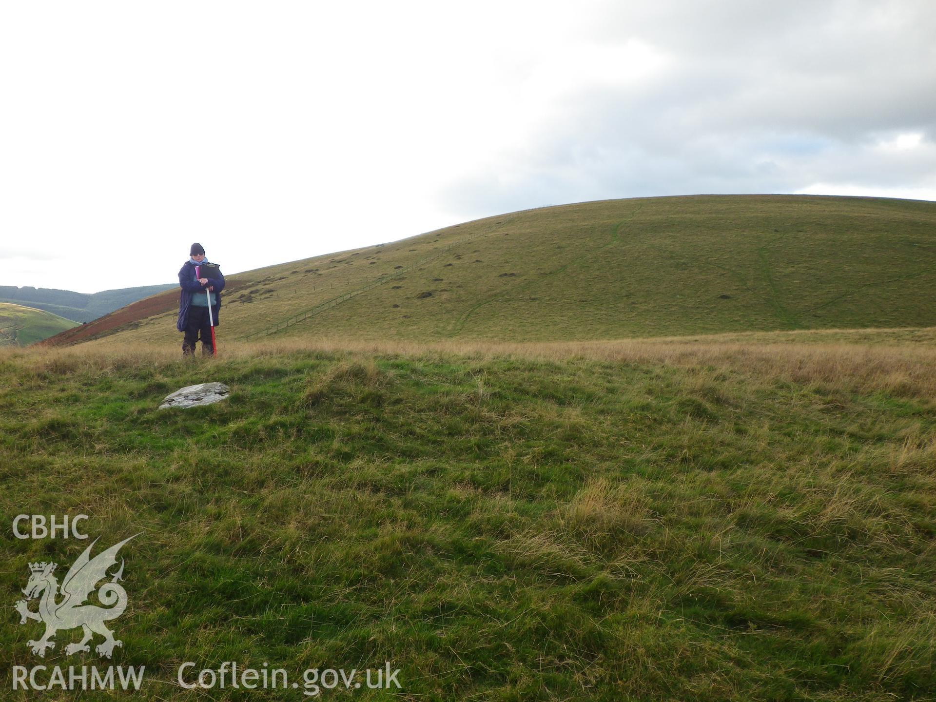 Low, grassed-over cairn, looking west northwest.