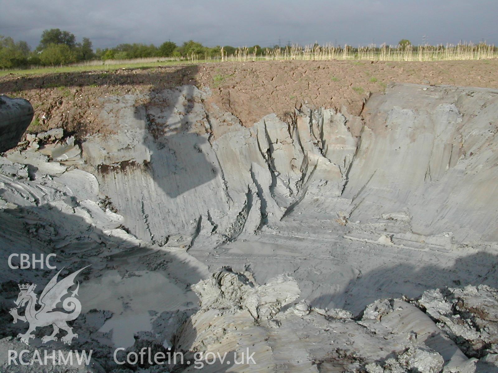 Colour digital photograph showing a reservoir pit, looking North East.