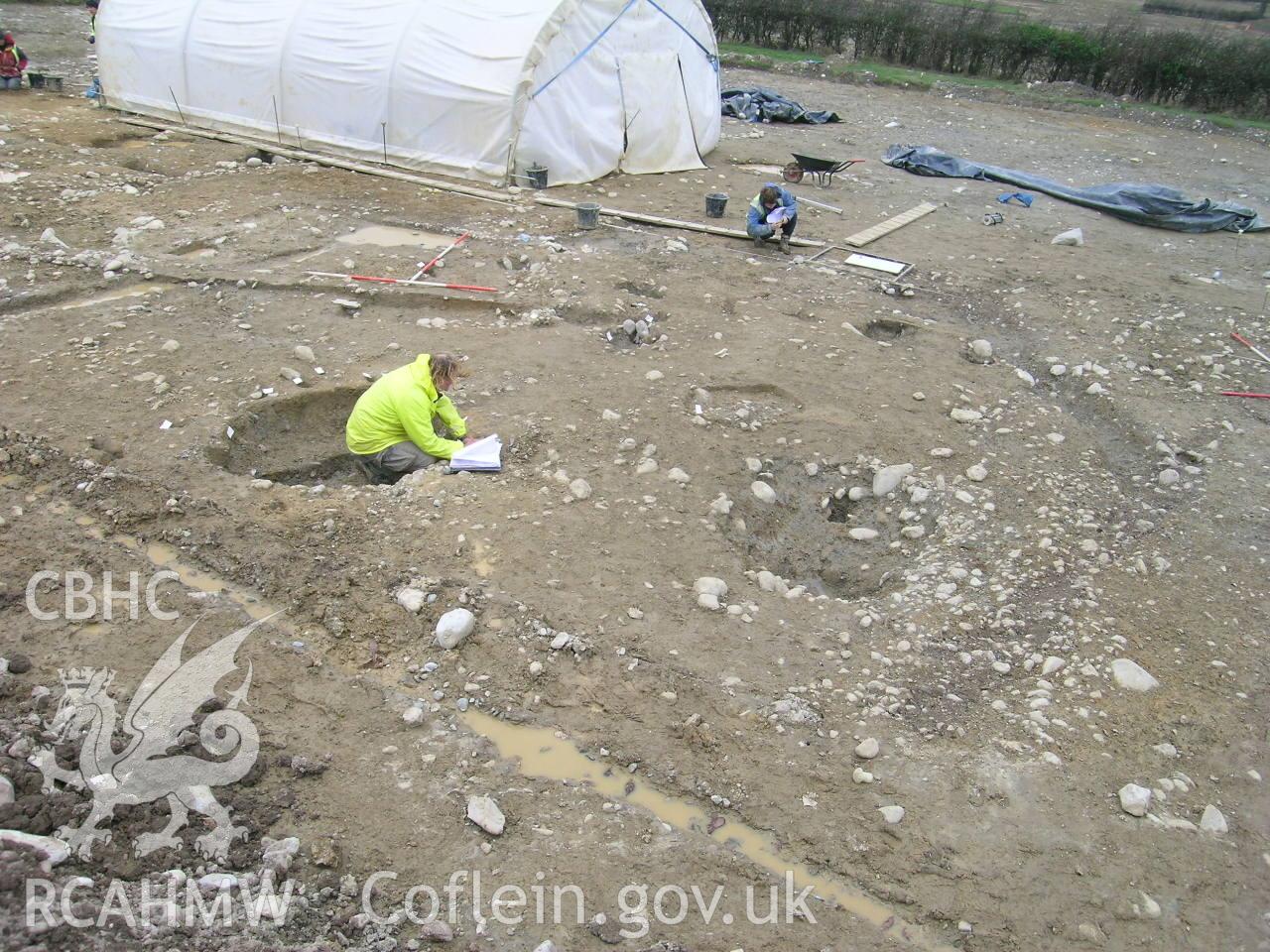 Digital photograph from excavation of Parc Bryn Cegin, Llandygai, by Gwynedd Archaeological Trust. General view RHG p-ex. [9352], from E (numbers refer to context records). Scale 4x2m.