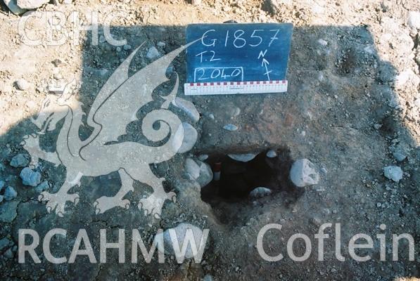 Photograph from excavation of Parc Bryn Cegin, Llandygai, by Gwynedd Archaeological Trust. post hole [2040], from SSW (numbers refer to context records). Scale 1x0.2m, 1x0.3m.