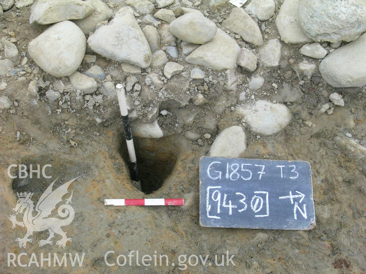 Digital photograph from excavation of Parc Bryn Cegin, Llandygai, by Gwynedd Archaeological Trust. Post-ex. [9430], from E (numbers refer to context records). Scale 1x0.5m, 1x0.2m.
