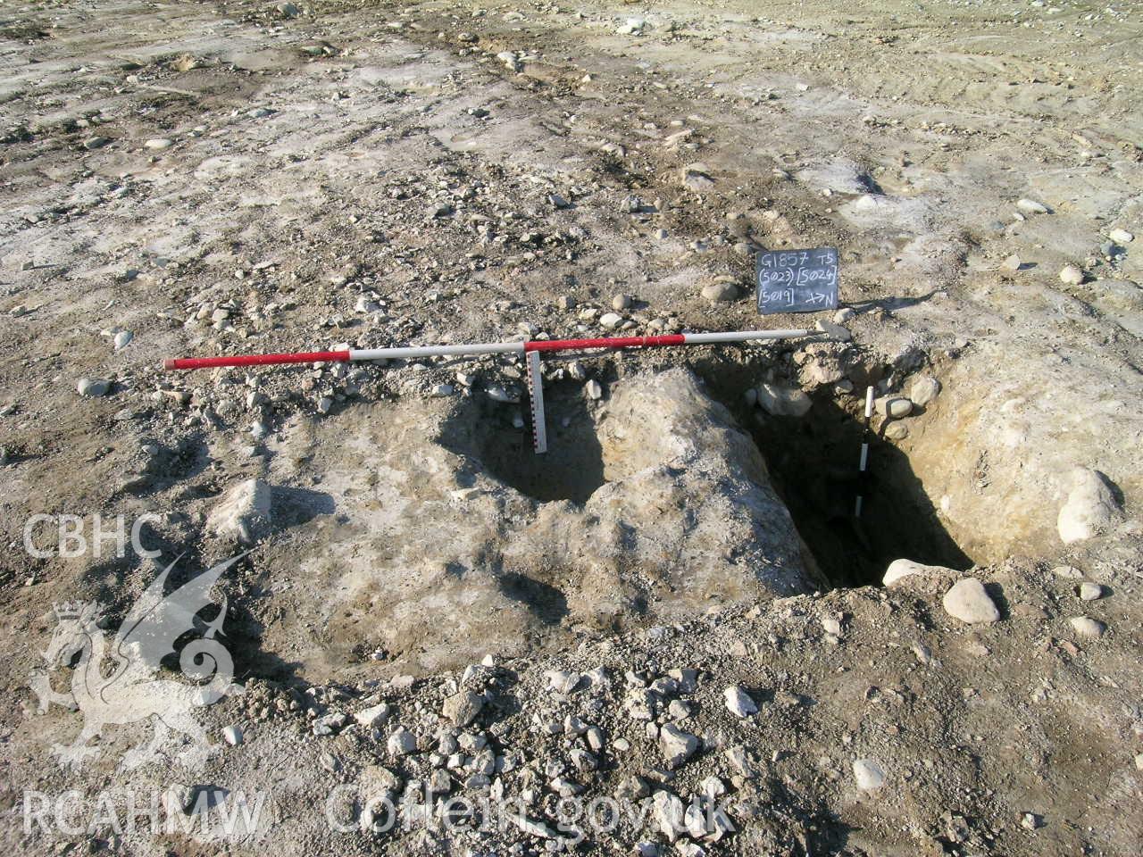 Digital photograph from excavation of Parc Bryn Cegin, Llandygai, by Gwynedd Archaeological Trust. Section through (5023) &[5024] & [5019], from E (numbers refer to context records). Scale 1x0.5m, 1x2m.