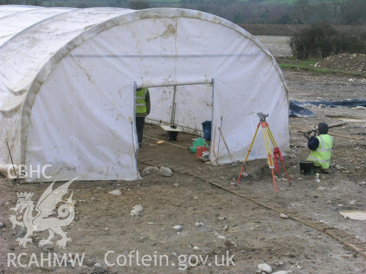 Digital photograph from excavation of Parc Bryn Cegin, Llandygai, by Gwynedd Archaeological Trust. Work shelter, from N (numbers refer to context records). Scale 1x0.5m.