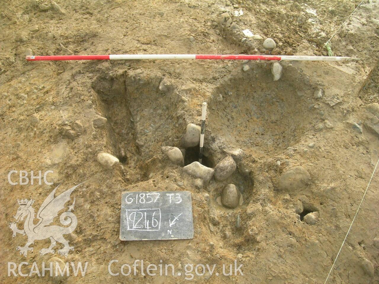 Digital photograph from excavation of Parc Bryn Cegin, Llandygai, by Gwynedd Archaeological Trust. Central feature of RHG [9246], from NE (numbers refer to context records). Scale 1x0.5m, 1x0.2.