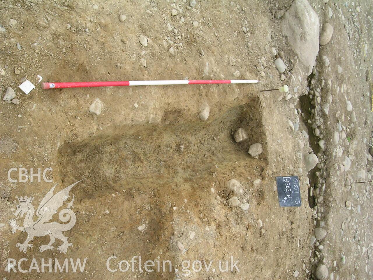 Digital photograph from excavation of Parc Bryn Cegin, Llandygai, by Gwynedd Archaeological Trust. Section through [3562], from SW (numbers refer to context records). Scale 1x2m.