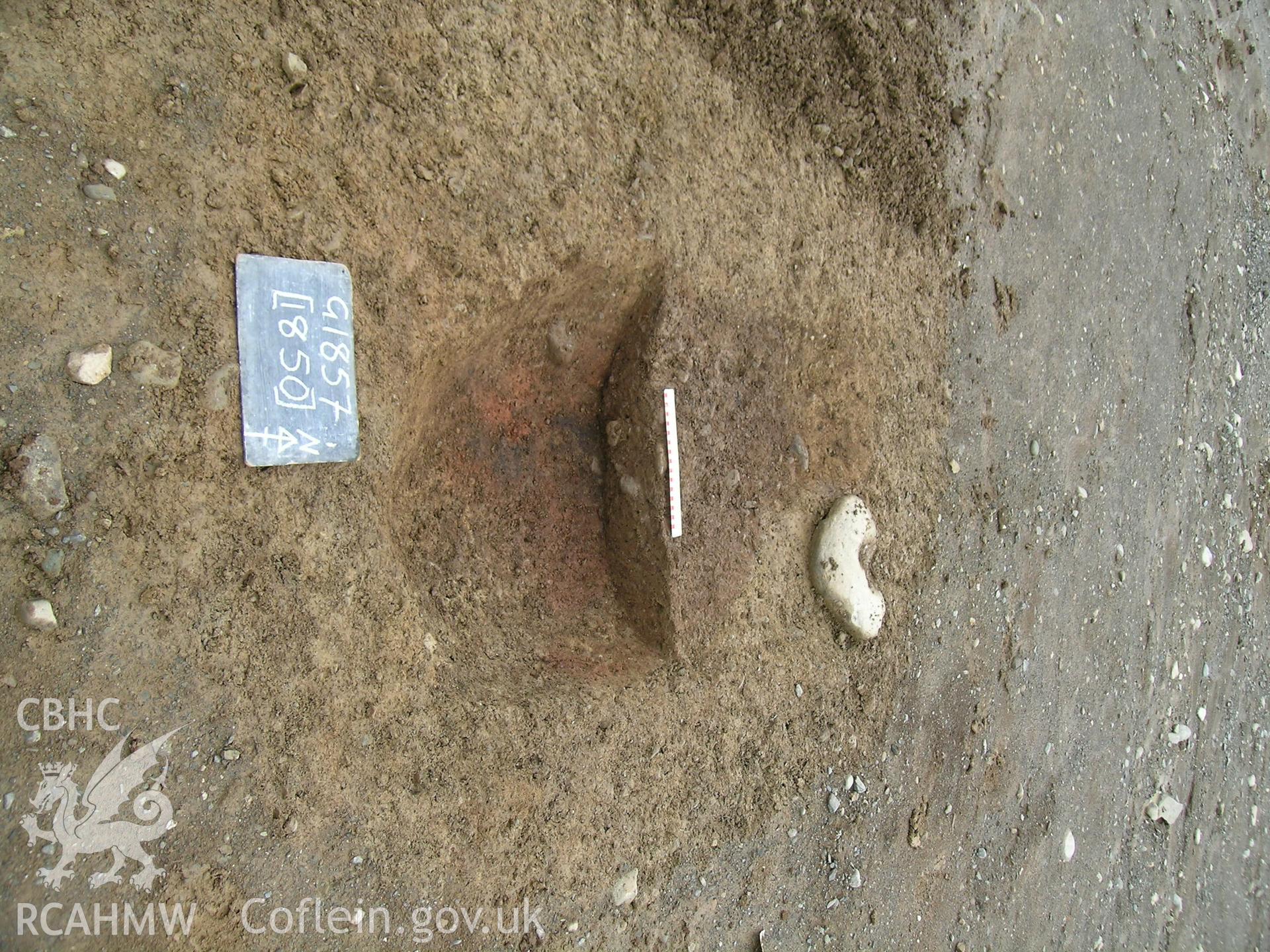 Digital photograph from excavation of Parc Bryn Cegin, Llandygai, by Gwynedd Archaeological Trust. 'Oven' cut [1850], from S (numbers refer to context records). Scale 0.2m.