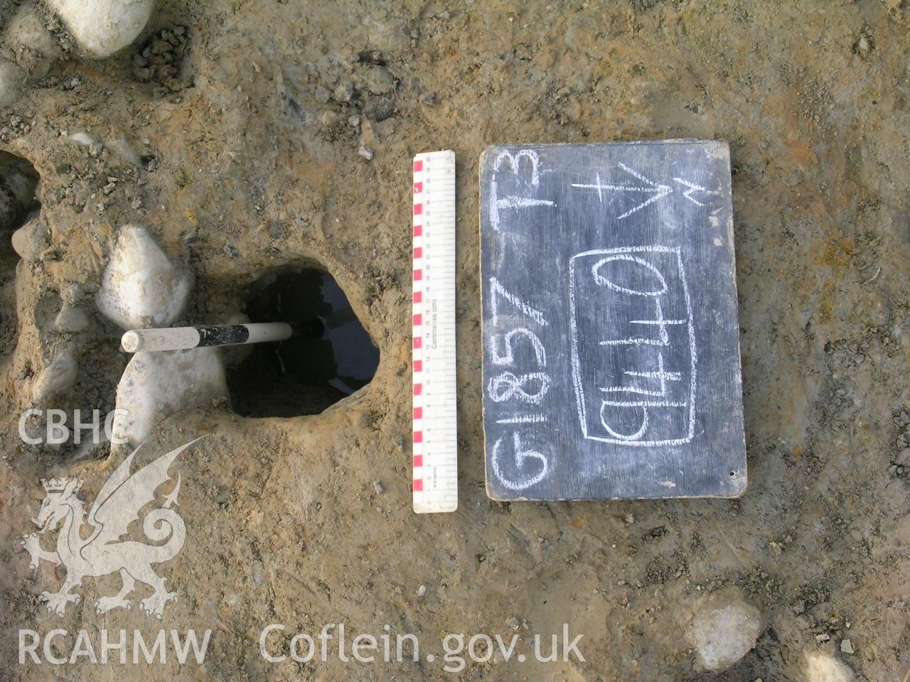 Digital photograph from excavation of Parc Bryn Cegin, Llandygai, by Gwynedd Archaeological Trust. Post-ex. Shot of [9440], from N (numbers refer to context records). Scale 1x0.3m, 1x0.5m.