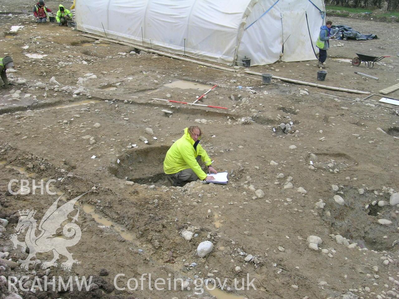 Digital photograph from excavation of Parc Bryn Cegin, Llandygai, by Gwynedd Archaeological Trust. General view RHG p-ex. [9352], from E (numbers refer to context records). Scale 2x2m.