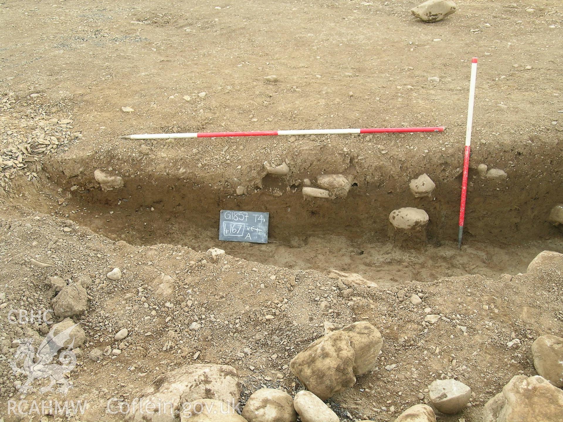 Digital photograph from excavation of Parc Bryn Cegin, Llandygai, by Gwynedd Archaeological Trust. Section [4167] (a), from W (numbers refer to context records). Scale 1x2m, 1x1m.