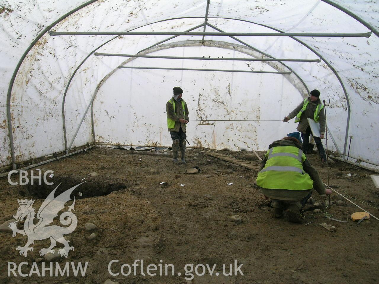 Digital photograph from excavation of Parc Bryn Cegin, Llandygai, by Gwynedd Archaeological Trust. Work shelter, from N (numbers refer to context records). Scale 1x0.5m.
