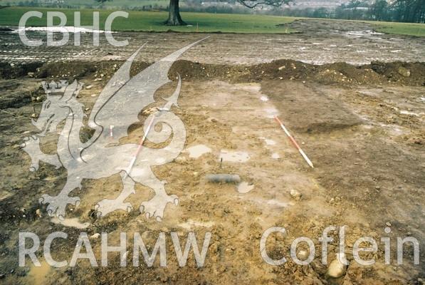 Photograph from excavation of Parc Bryn Cegin, Llandygai, by Gwynedd Archaeological Trust. View of ditches [1042] & [1044], from SW (numbers refer to context records). Scale 2x2m.