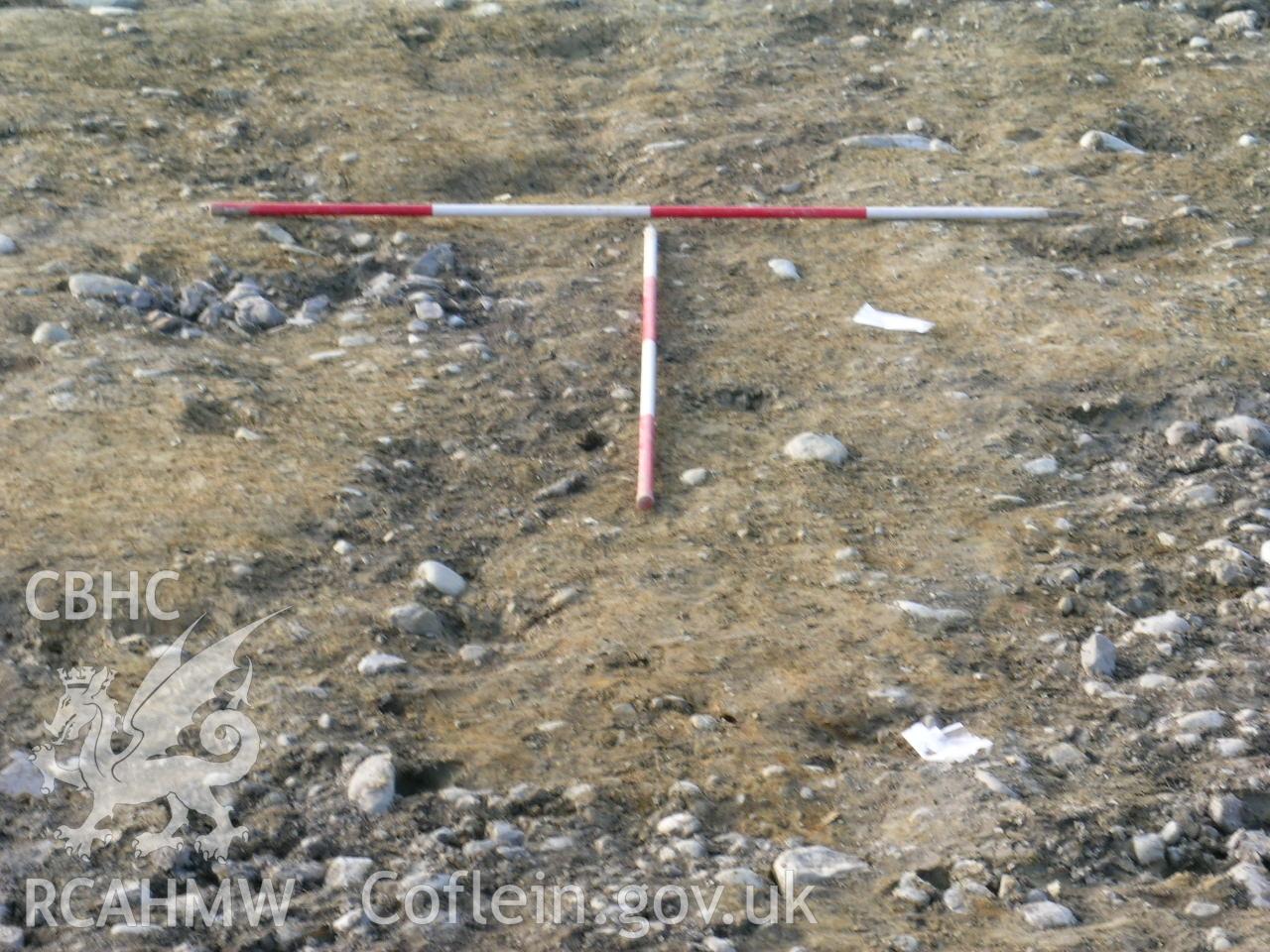 Digital photograph from excavation of Parc Bryn Cegin, Llandygai, by Gwynedd Archaeological Trust. Working shot RHG [9352], from E (numbers refer to context records). Scale 2x2m.