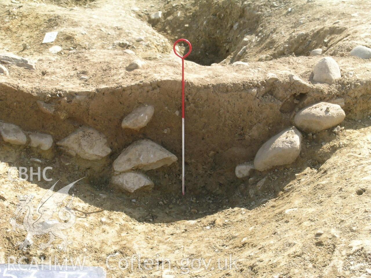 Digital photograph from excavation of Parc Bryn Cegin, Llandygai, by Gwynedd Archaeological Trust. Roundhouse 'A' PX [3266], from W (numbers refer to context records). Scale 0.4m.