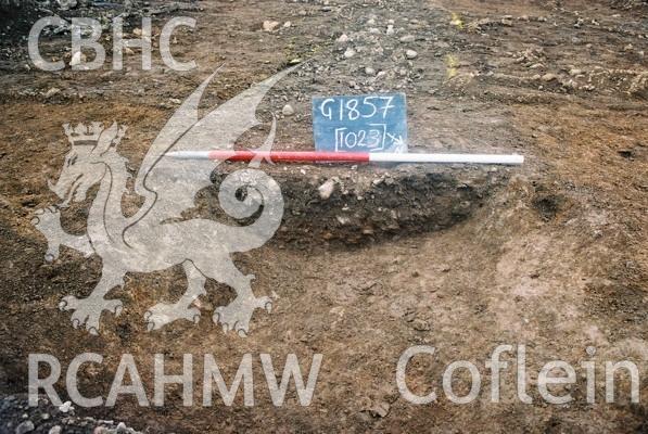 Photograph from excavation of Parc Bryn Cegin, Llandygai, by Gwynedd Archaeological Trust. Ditch  [1023], from NE (numbers refer to context records). Scale 1x1m.