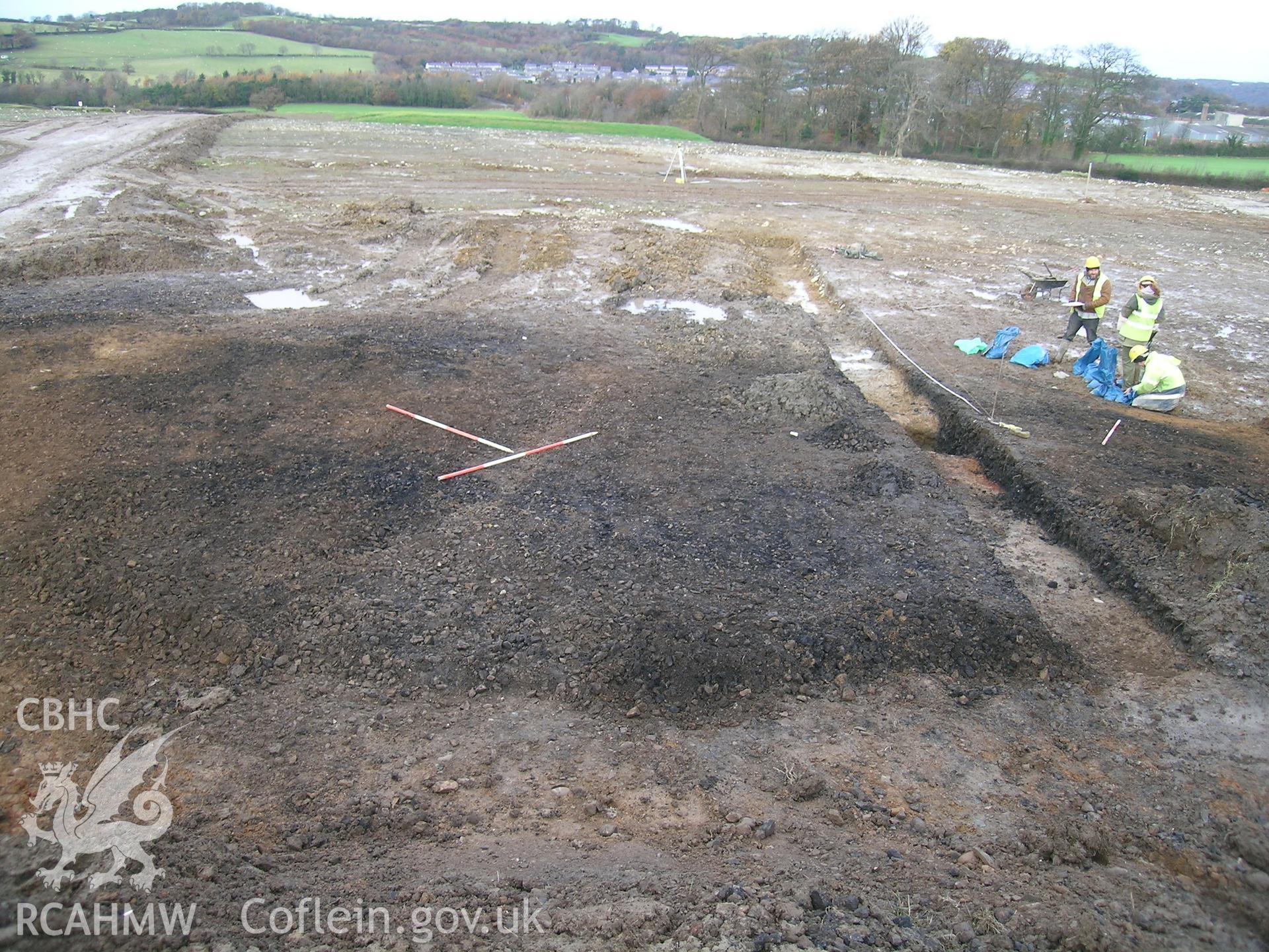 Digital photograph from excavation of Parc Bryn Cegin, Llandygai, by Gwynedd Archaeological Trust. Burnt mound (2176), from ESE (numbers refer to context records). Scale 3x2m.