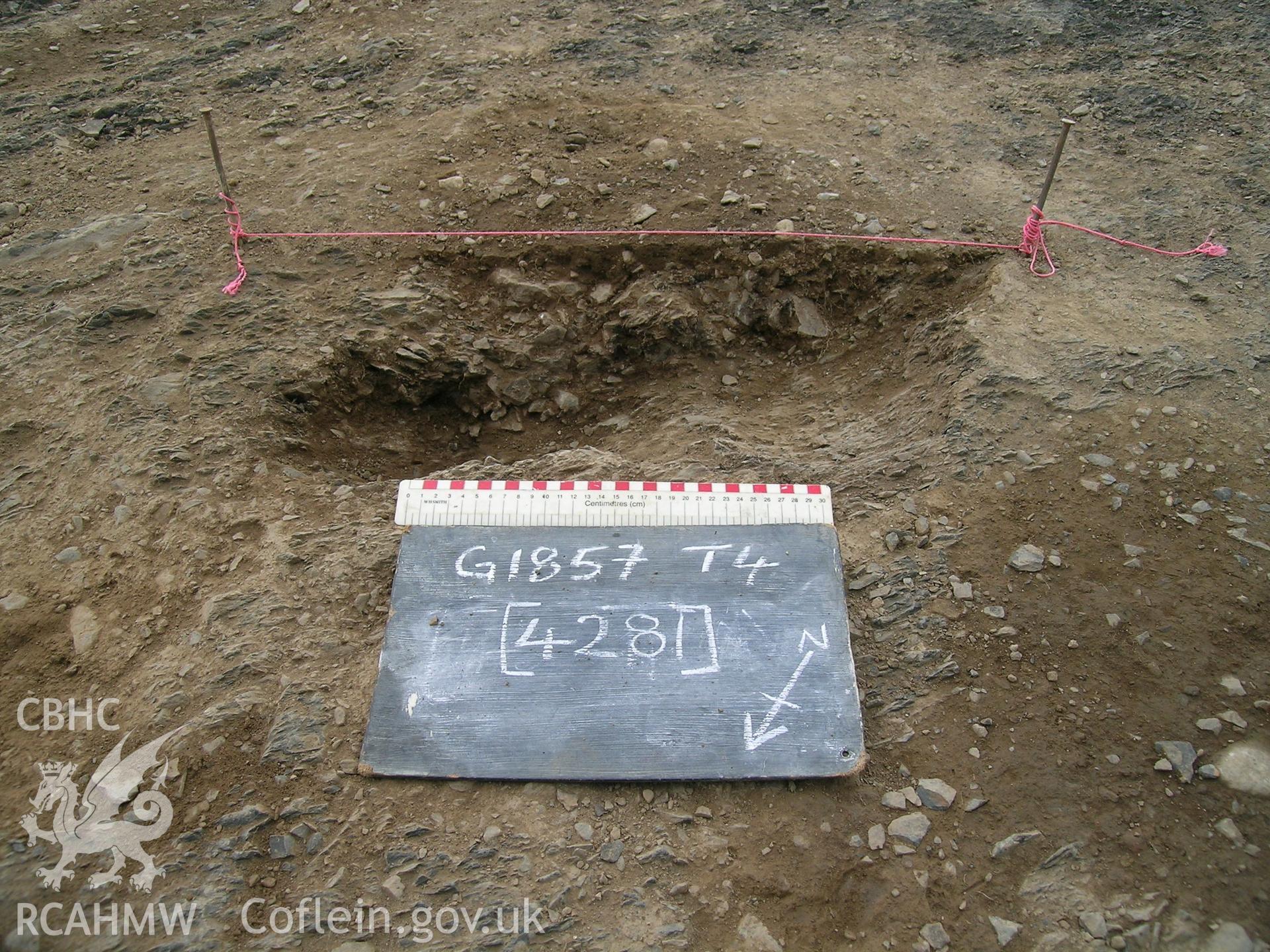 Digital photograph from excavation of Parc Bryn Cegin, Llandygai, by Gwynedd Archaeological Trust. PH [4244], from NE (numbers refer to context records). Scale 1x0.3m.