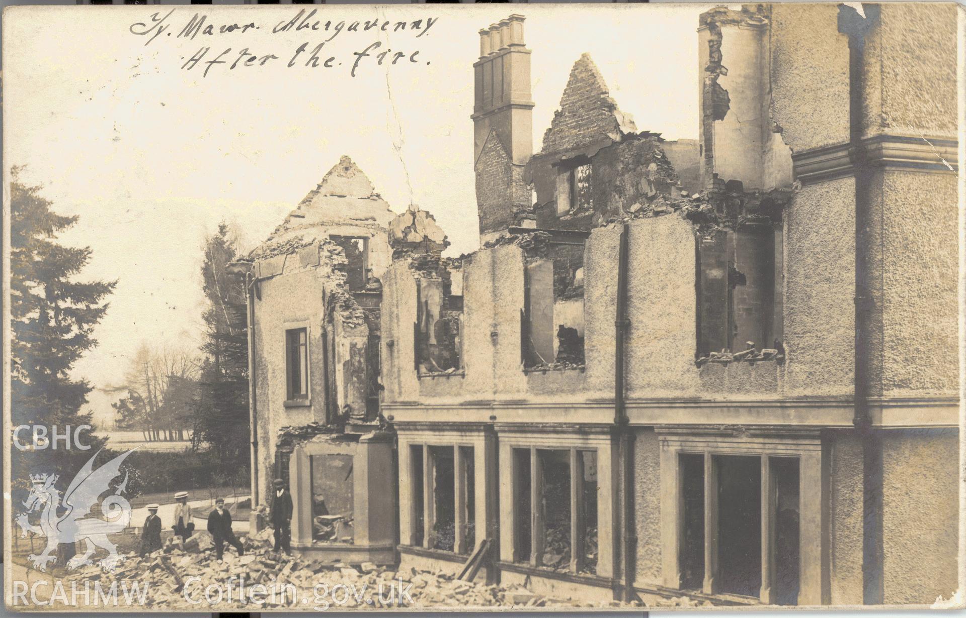 Digitised postcard image of Ty-Mawr, Gilwern,  aftermath of fire with figures. Produced by Parks and Gardens Data Services, from an original item in the Peter Davis Collection at Parks and Gardens UK. We hold only web-resolution images of this collection, suitable for viewing on screen and for research purposes only. We do not hold the original images, or publication quality scans.