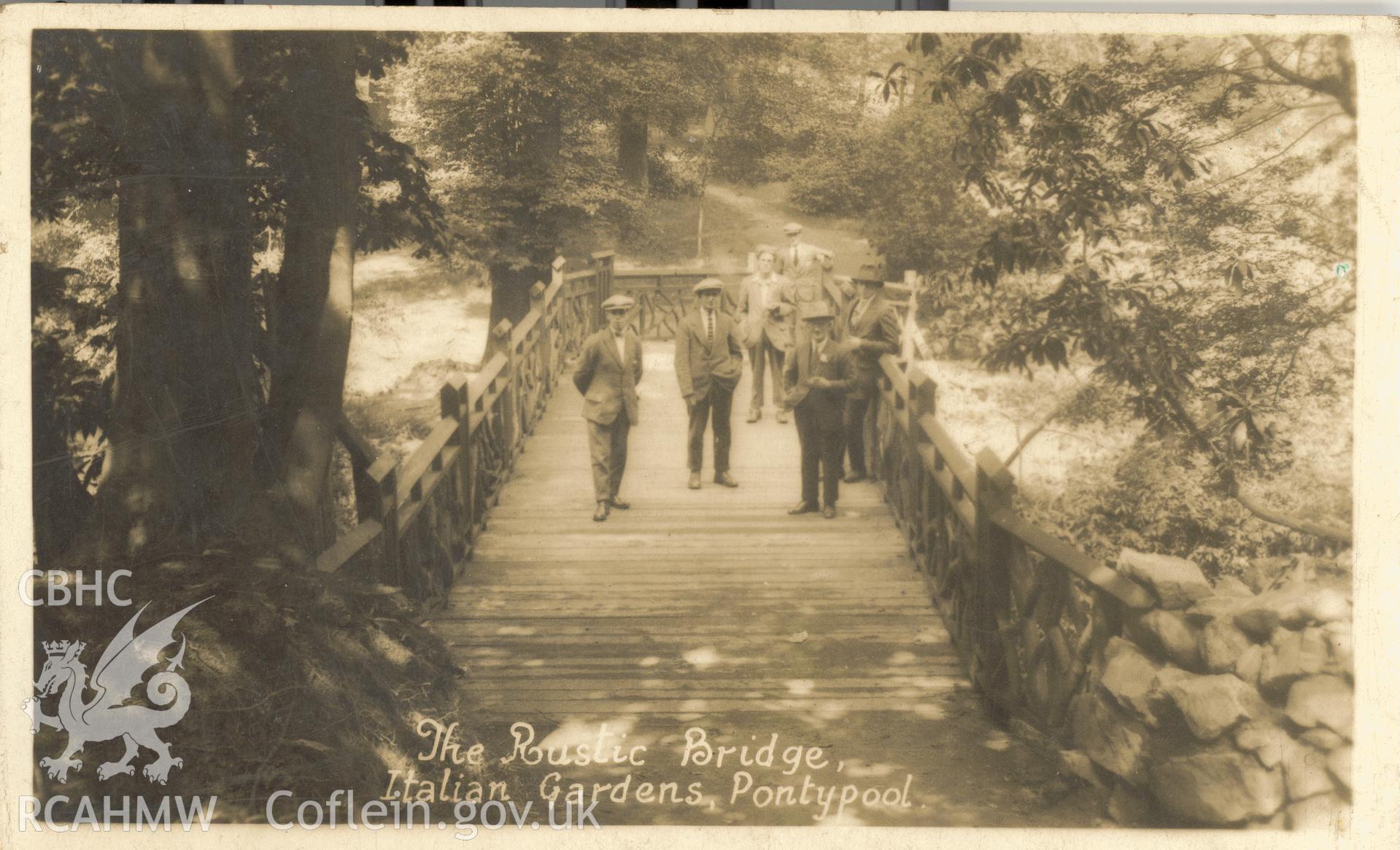 Digitised postcard image of the Rustic Bridge, Italian Gardens, Pontypool Park, Viner and Co. Produced by Parks and Gardens Data Services, from an original item in the Peter Davis Collection at Parks and Gardens UK. We hold only web-resolution images of this collection, suitable for viewing on screen and for research purposes only. We do not hold the original images, or publication quality scans.