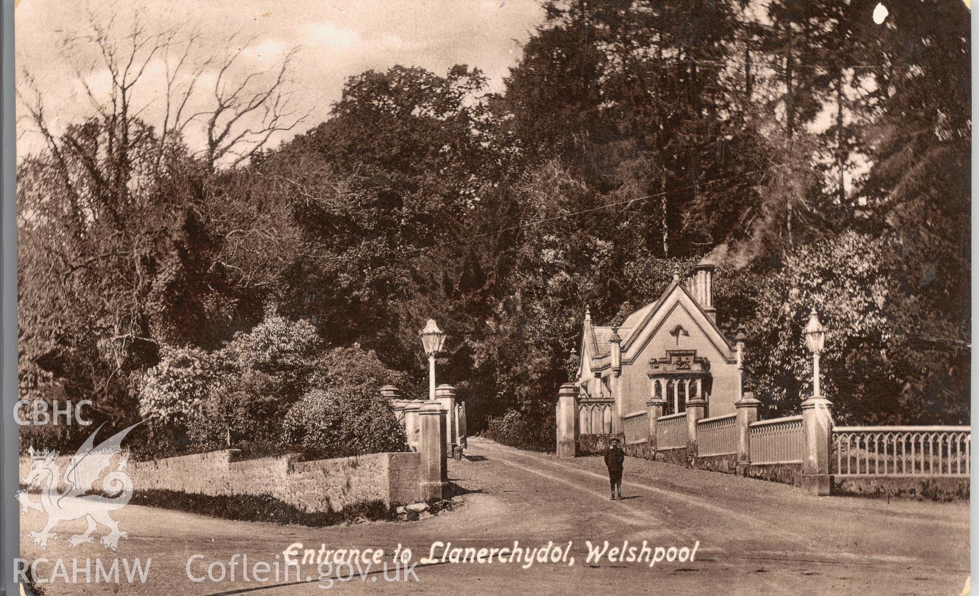 Digitised postcard image of First Lodge, Llanerchydol Hall, Welshpool, with figure, Valentines Series. Produced by Parks and Gardens Data Services, from an original item in the Peter Davis Collection at Parks and Gardens UK. We hold only web-resolution images of this collection, suitable for viewing on screen and for research purposes only. We do not hold the original images, or publication quality scans.