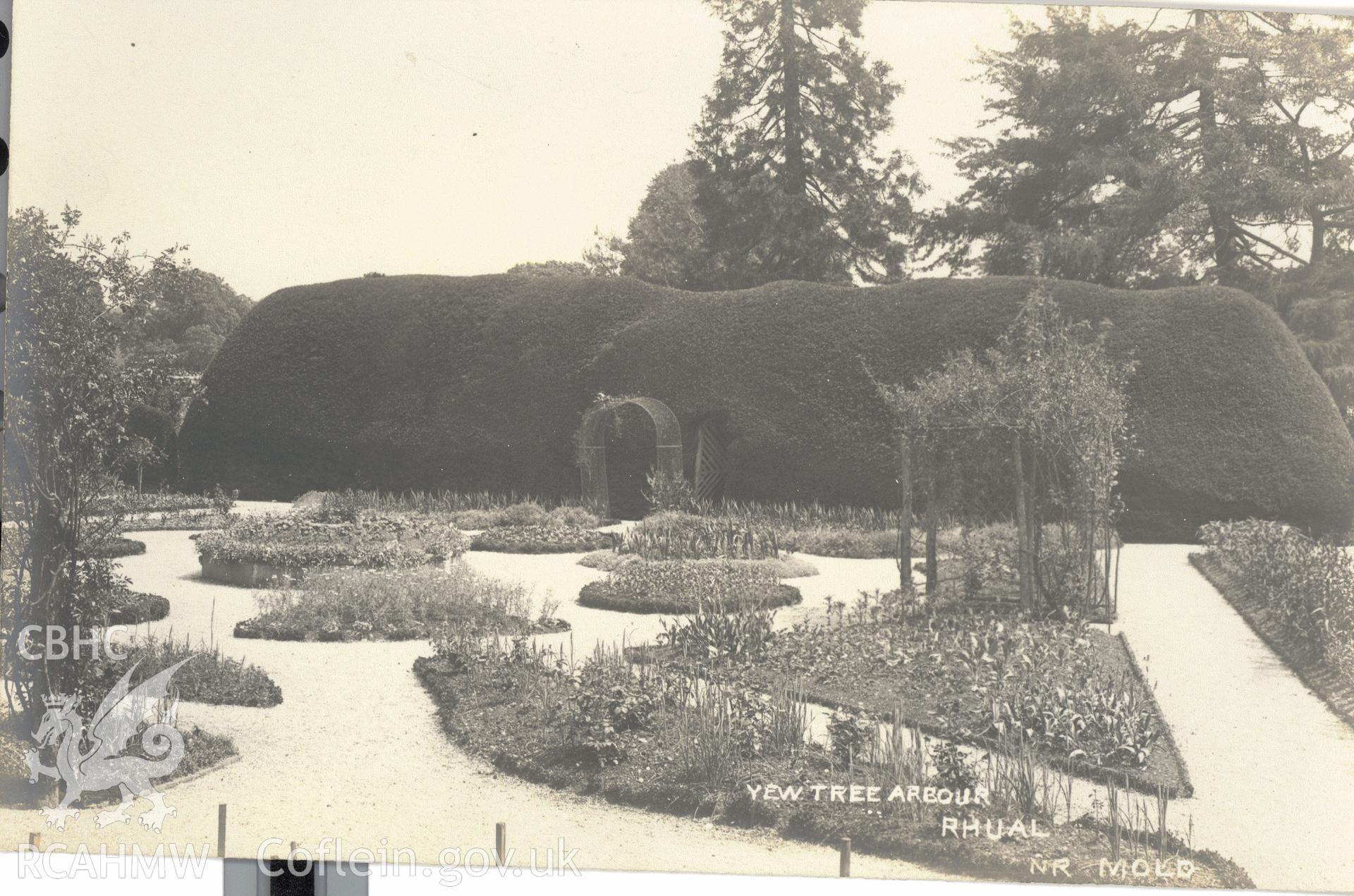 Digitised postcard image of Rhual Hall garden, Mold, including Yew Tree arbour, The "Dingle" Series Bevan, Heswall. Produced by Parks and Gardens Data Services, from an original item in the Peter Davis Collection at Parks and Gardens UK. We hold only web-resolution images of this collection, suitable for viewing on screen and for research purposes only. We do not hold the original images, or publication quality scans.