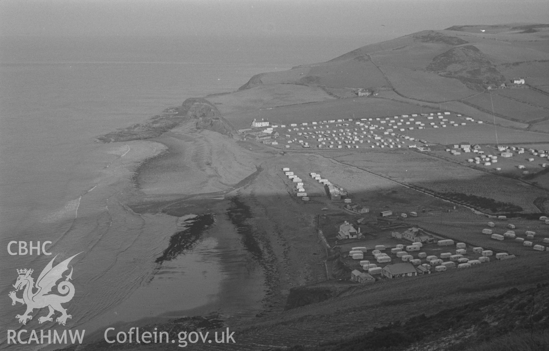 Black and White photograph showing view of Clarach from the upper footpath on the north side of Constitution hill, with caravans. Photographed by Arthur Chater in December 1962 from Grid Reference SN 587 833, looking north.