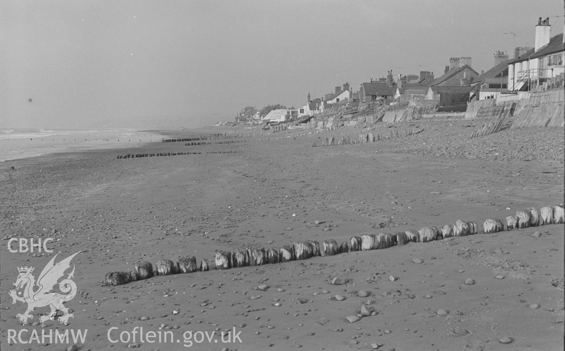 Black and White photograph showing breakwater, houses and beach defences at Borth. Photographed by Arthur Chater in February 1963, from Grid Reference SN c. 608 894, looking north.