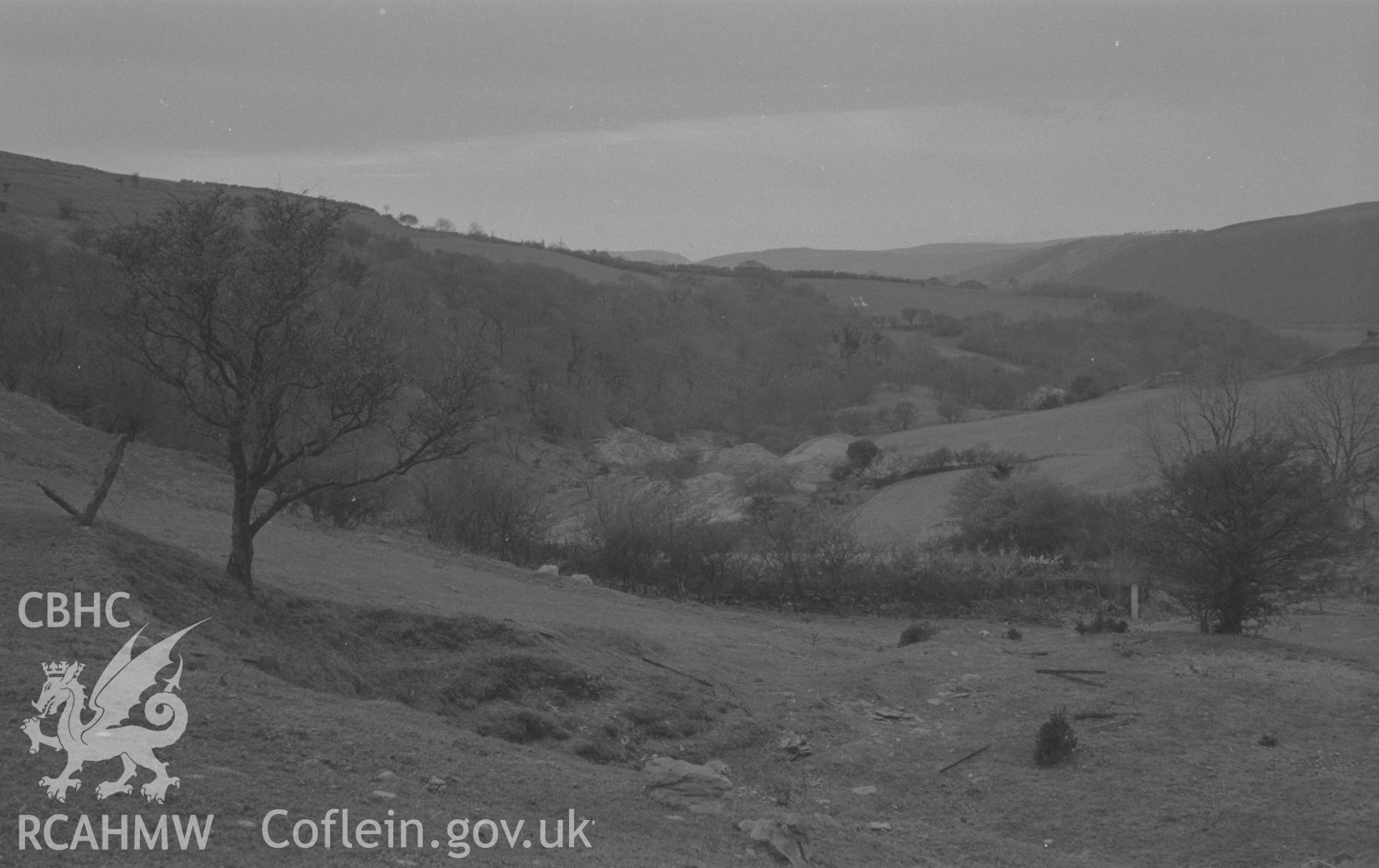 Black and White photograph showing view down the valley to Llechwedd-Helyg lead mine remains. Photographed by Arthut Chater in December 1961, from Grid Reference SN 686 849, looking east.