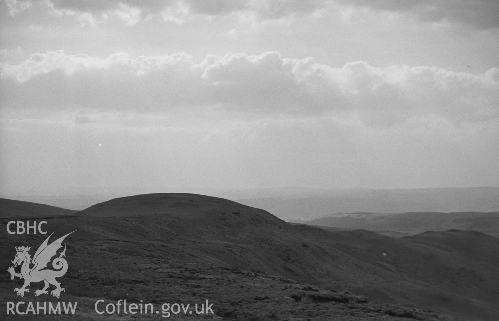 Black and White photograph showing Castell Rhyfel iron-age camp from the east. Photographed by Arthur Chater in April 1962 from Grid Reference SN 737 600, looking west south west.