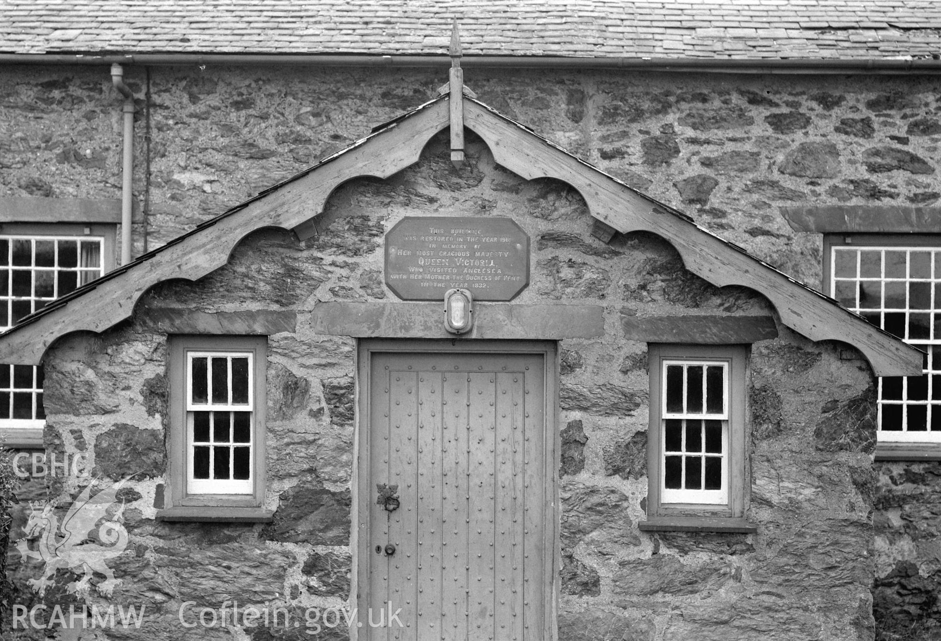 View of front entrance and plaque above