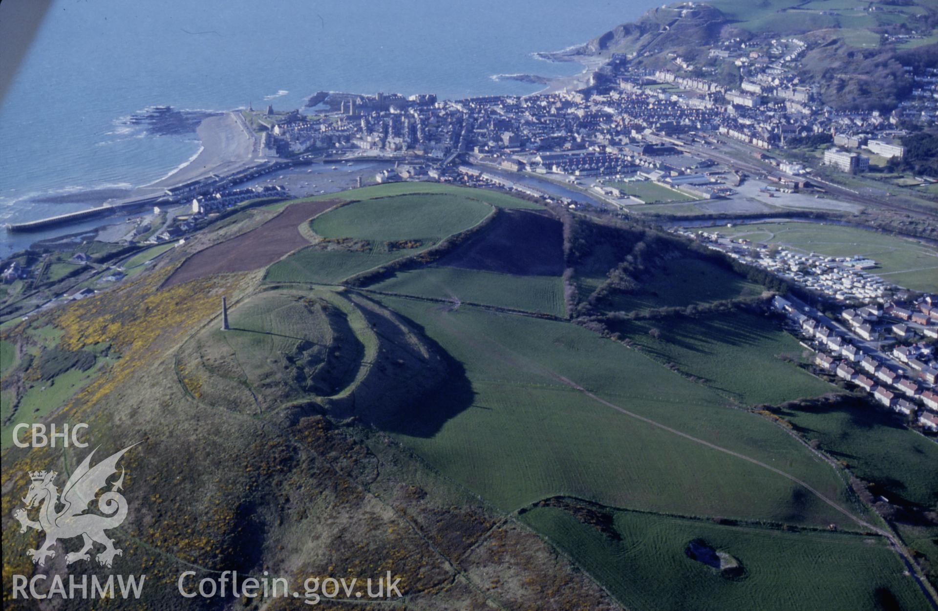 Slide of RCAHMW colour oblique aerial photograph of Pen Dinas Camp, taken by C.R. Musson, 25/4/1989.