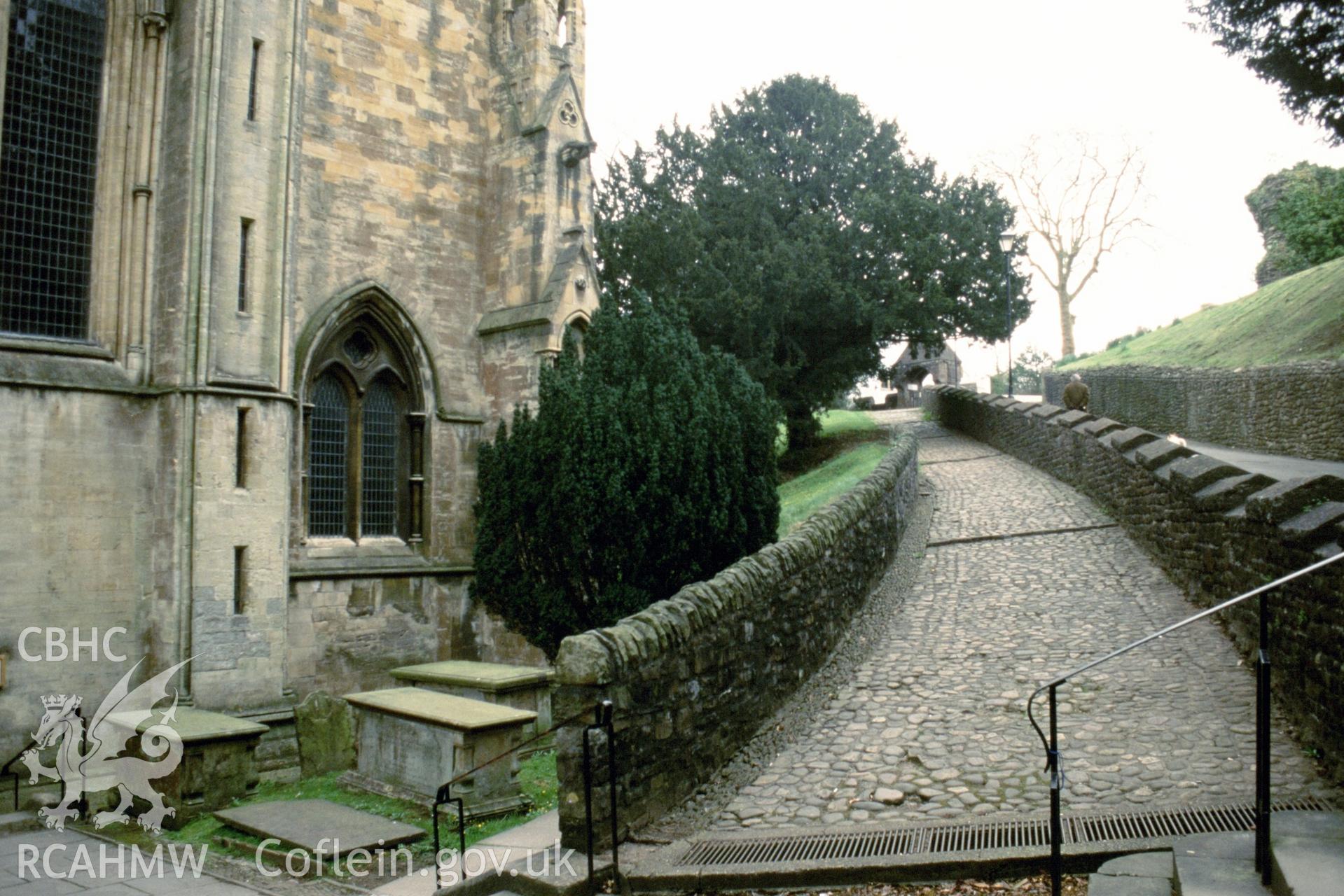 Exterior, W. end, part, & view up cobbled path to lychgate