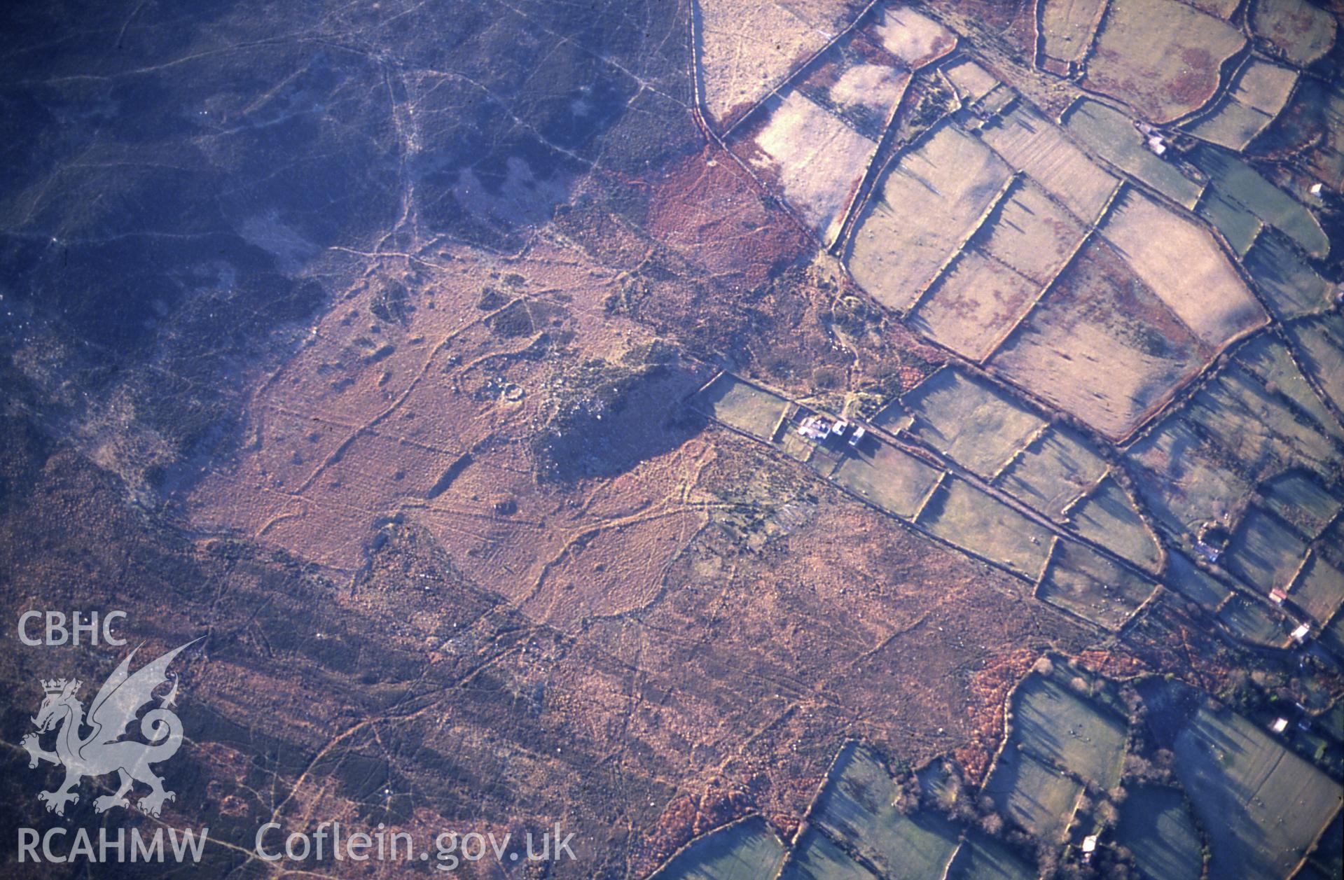 RCAHMW colour slide oblique aerial photograph of possible settlement features on the north face of Mynydd Carningli, Newport, taken on 13/01/1991 by CR Musson