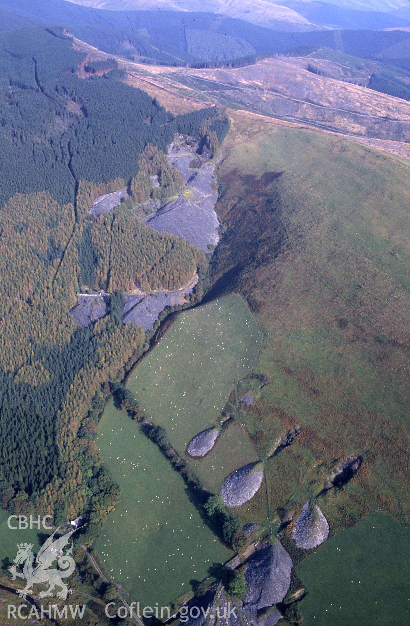 RCAHMW colour slide oblique aerial photograph of Cymerau North Slate Quarry (nprn 400826) from the southwest, with Ratgoed Slate Quarries (nprn 400827) in the background., taken by C.R. Musson, 09/10/94