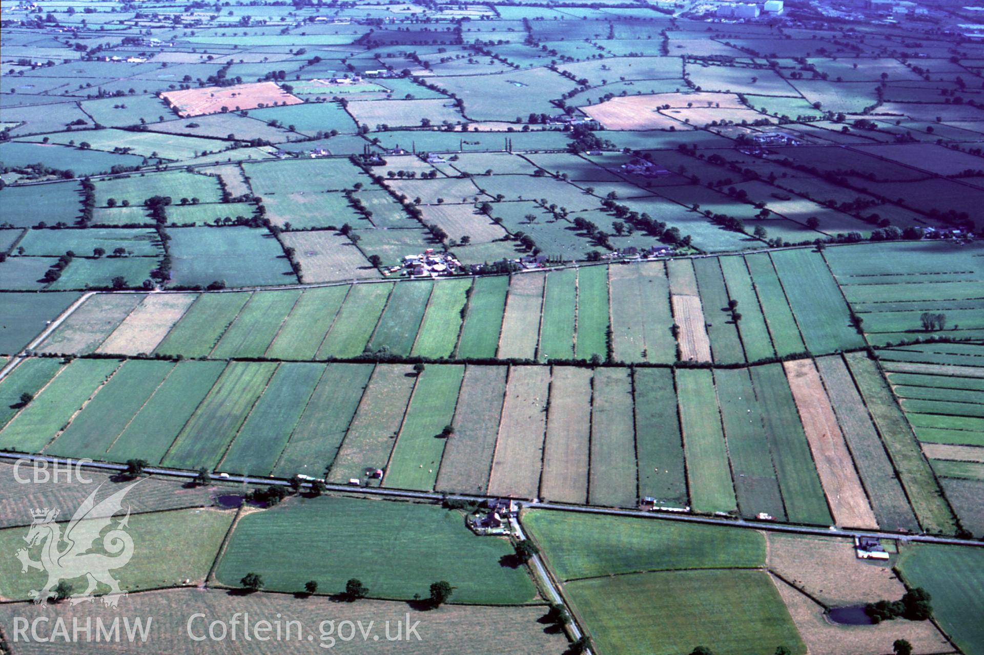 RCAHMW colour slide oblique aerial photograph of Commonwood, Holt, taken by C.R. Musson, 13/08/94