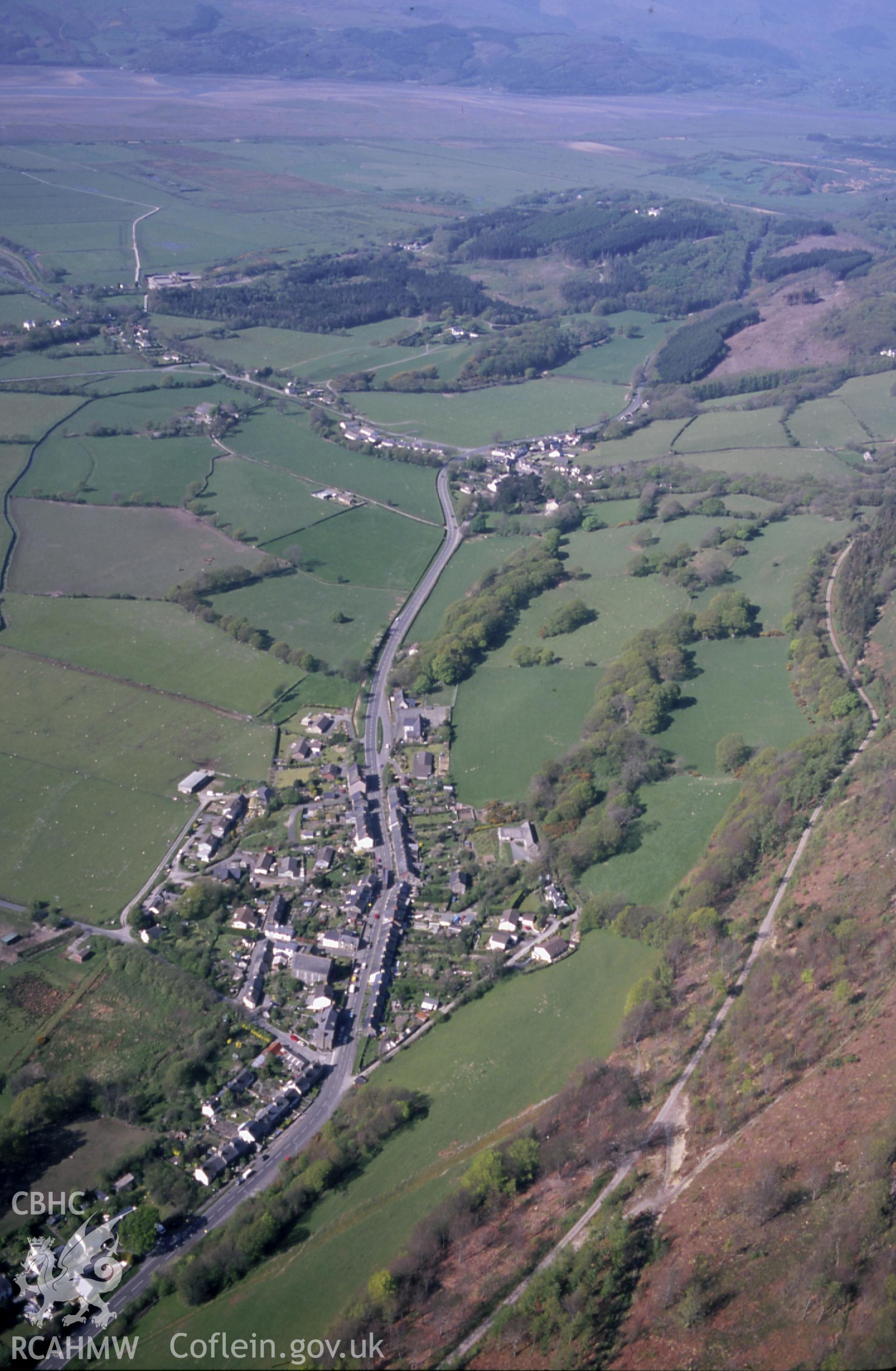 RCAHMW colour slide oblique aerial photograph of Tre Taliesin, Llangynfelyn, taken on 29/04/1999 by Toby Driver