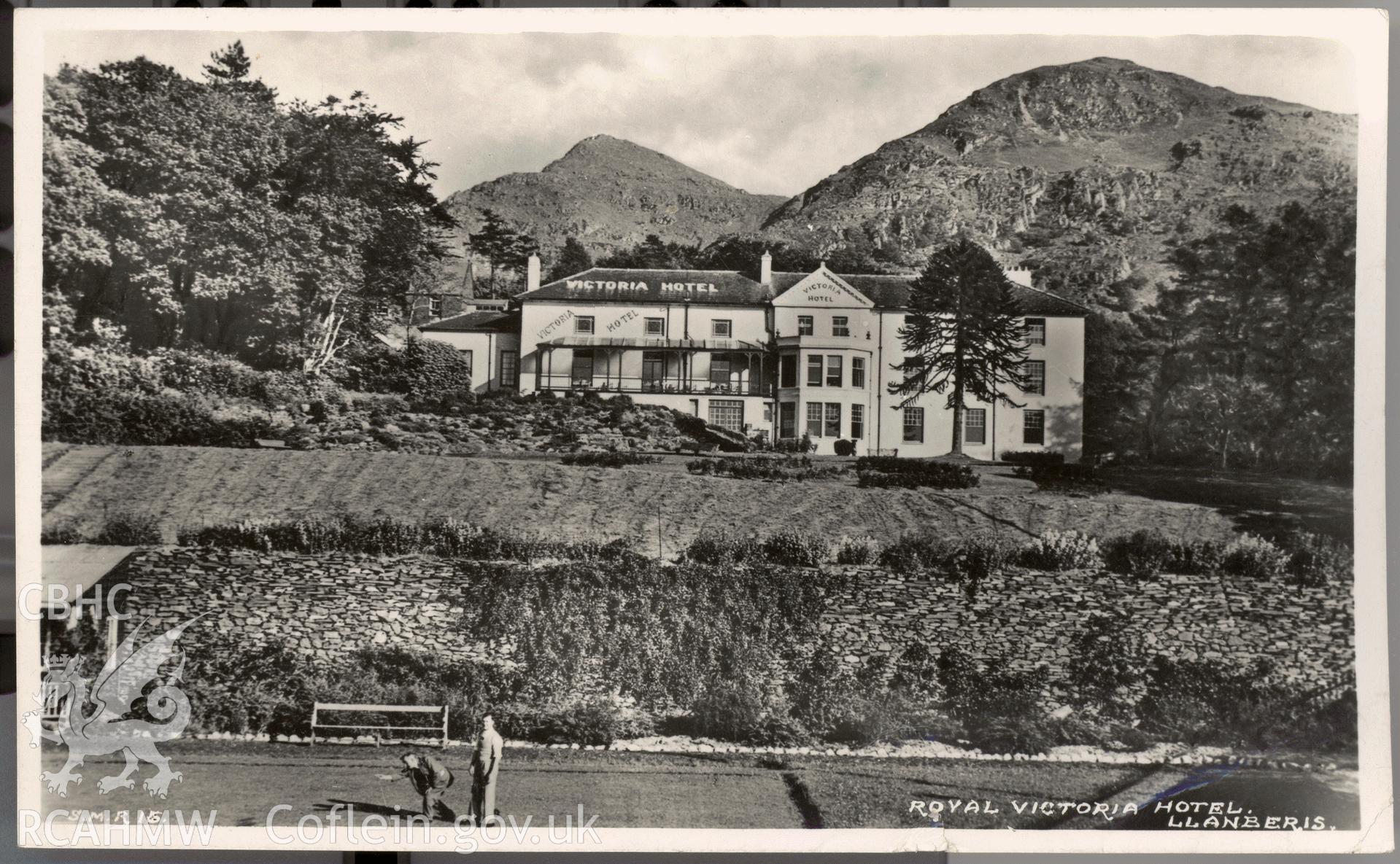 Digitised postcard image of Royal Victoria Hotel, Llanberis, with bowling green and figures. Produced by Parks and Gardens Data Services, from an original item in the Peter Davis Collection at Parks and Gardens UK. We hold only web-resolution images of this collection, suitable for viewing on screen and for research purposes only. We do not hold the original images, or publication quality scans.