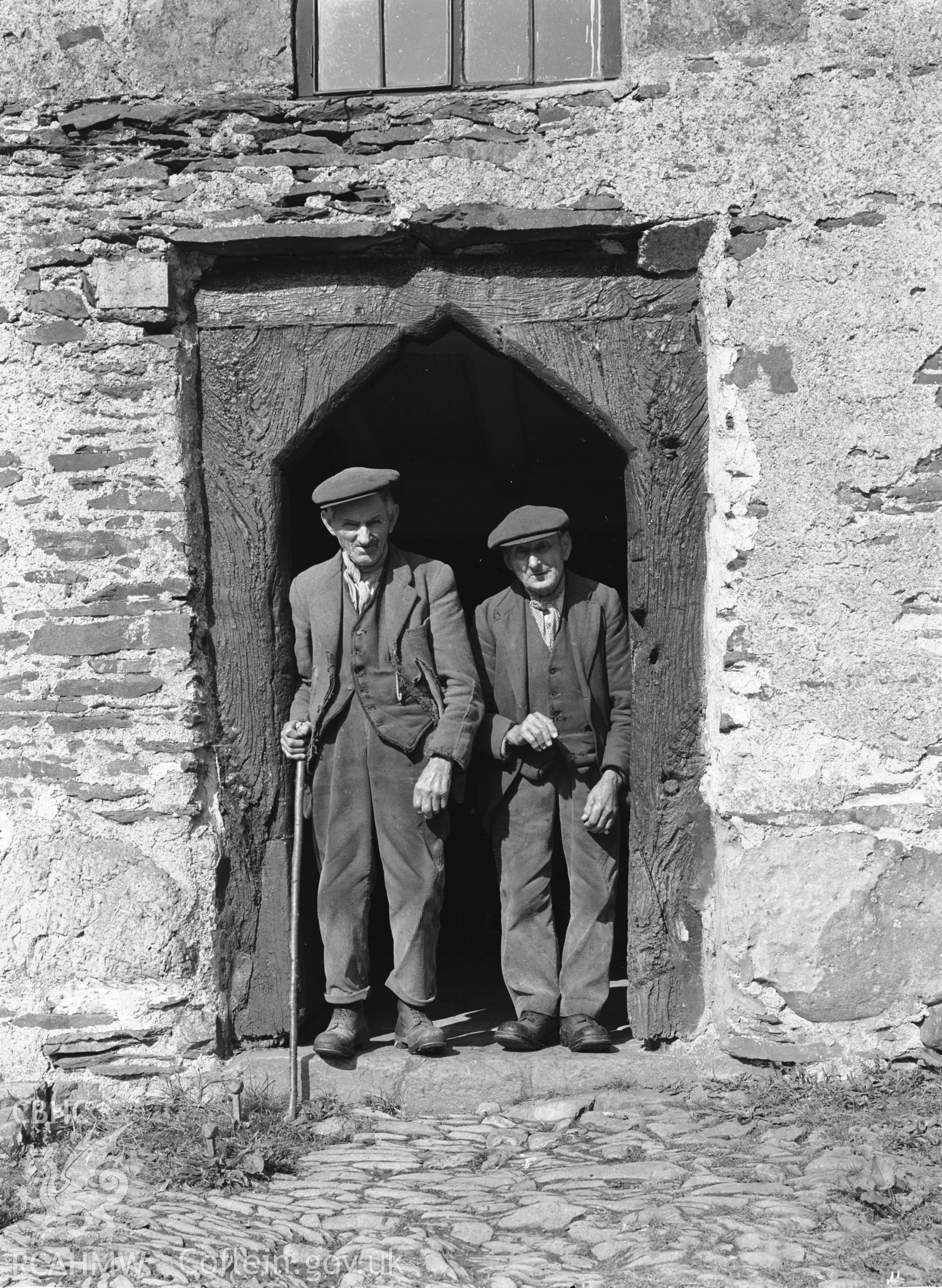 Exterior: arched doorway, with the brothers Morris