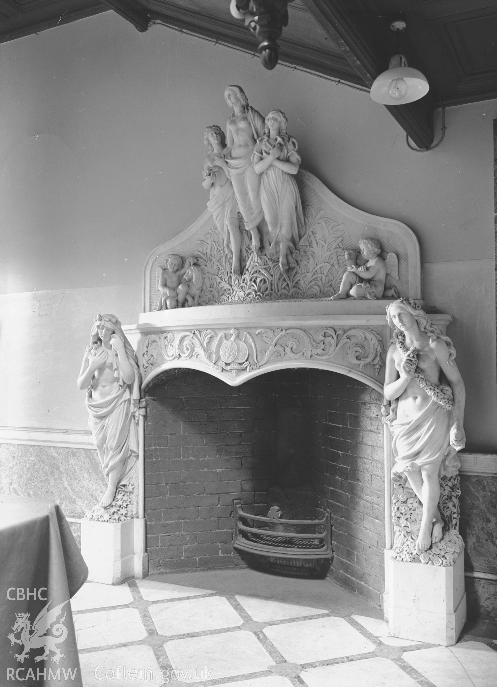 Interior: marble fireplace under main staircase