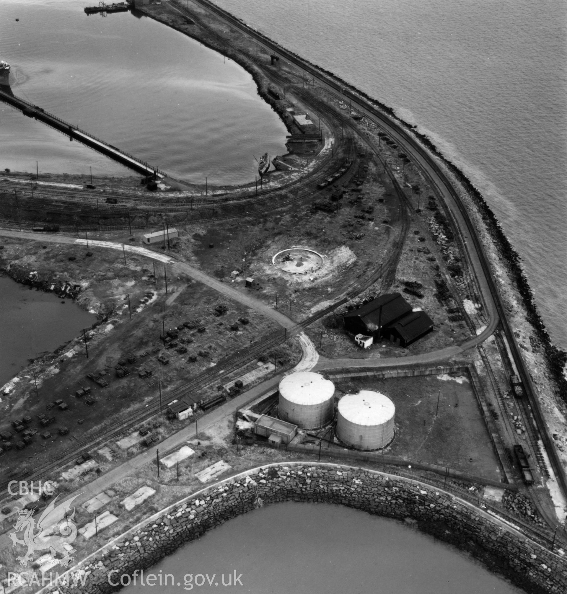 View of oil tanks at Queen's Dock, Swansea from National Oil Refinery, Llandarcy. Oblique aerial photograph, 5?" cut roll film.