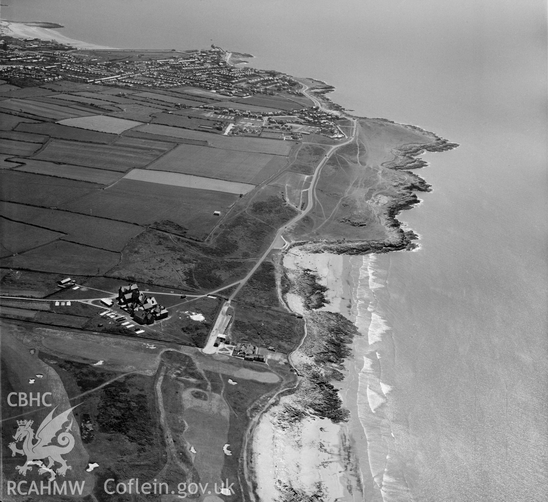 View of Royal Porthcawl golf club showing distant Porthcawl in the distance