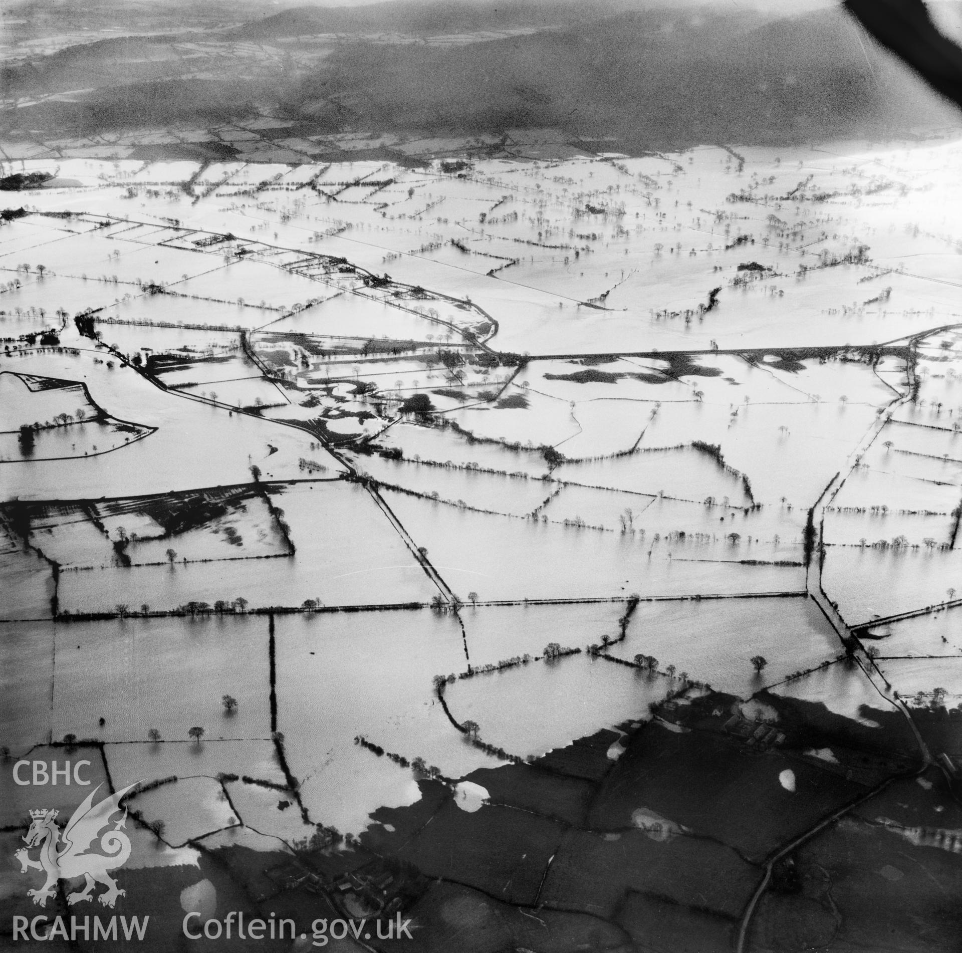 View of the river Severn in flood in the Criggion and Breiddan Hill area. Oblique aerial photograph, 5?" cut roll film.