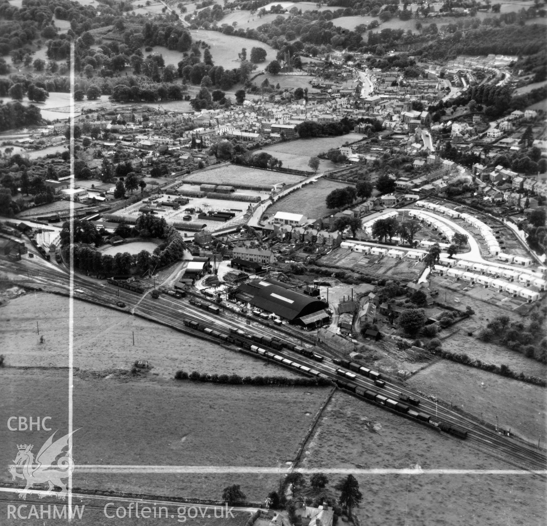 View of Welshpool showing Boys & Boden Ltd., Mill Lane, and prefab bungalows. Oblique aerial photograph, 5?" cut roll film.
